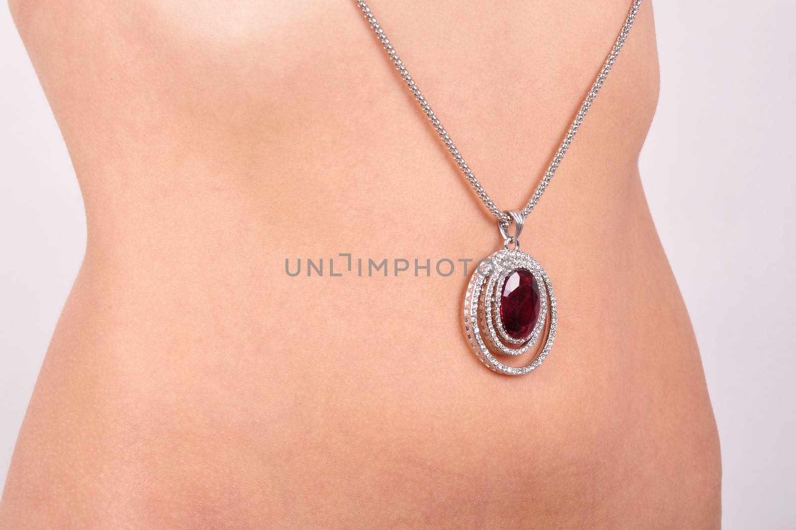 pendant on a background of the body of a young woman