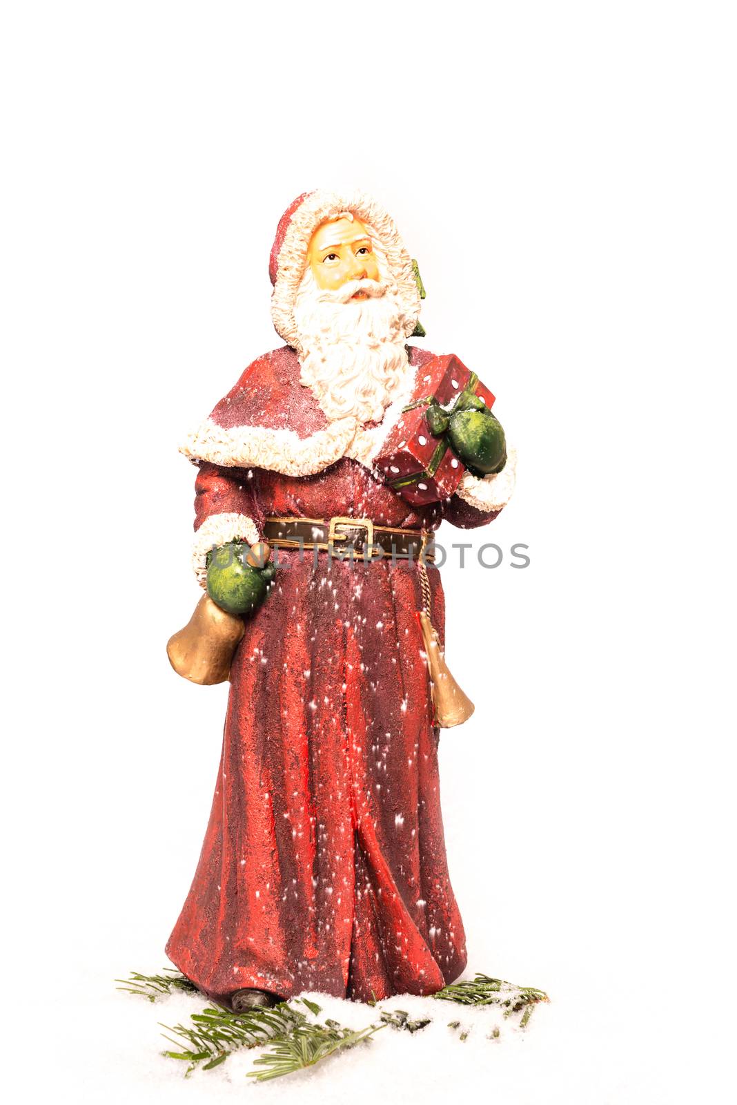 Santa Claus figure christmas decoration in artificial snow with white background
