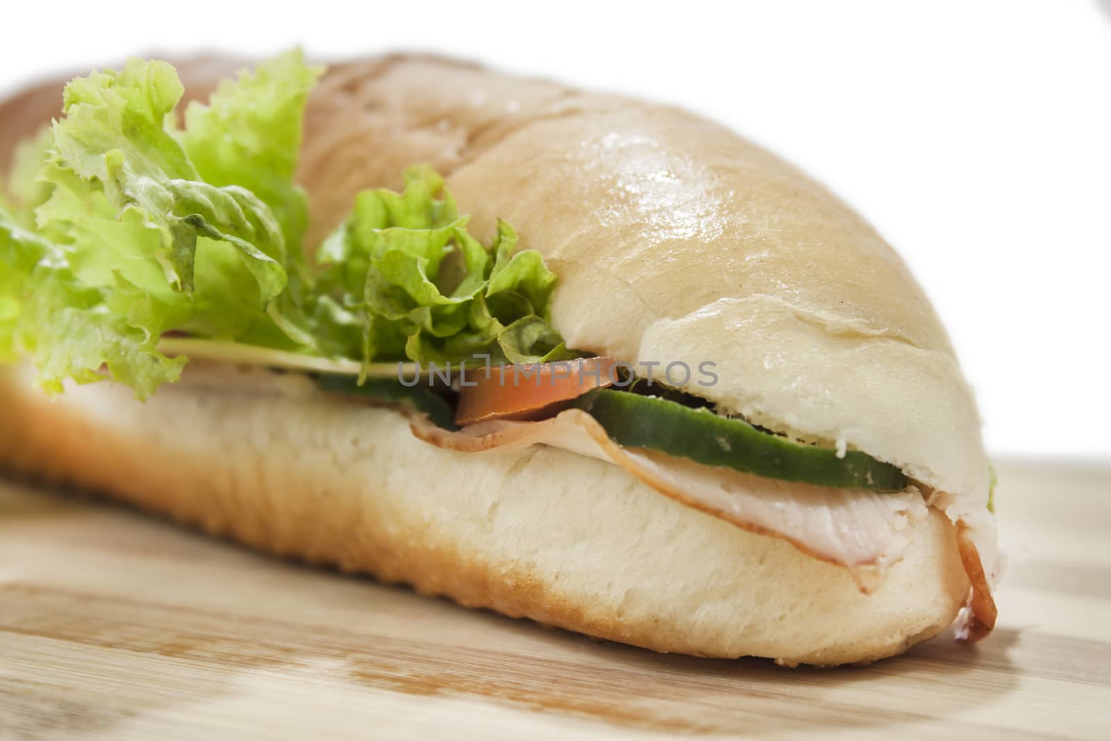 Sandwich in shalow depth of field on wooden board.