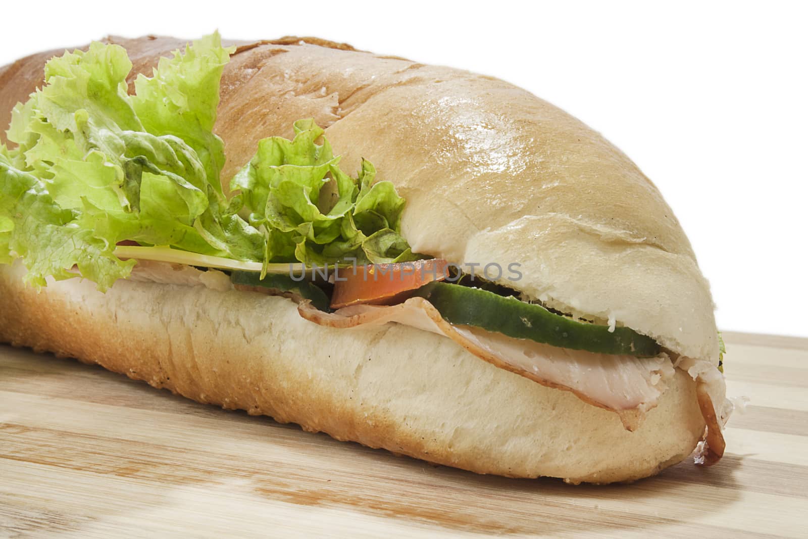 Sandwich in deep depth of field on wooden board.