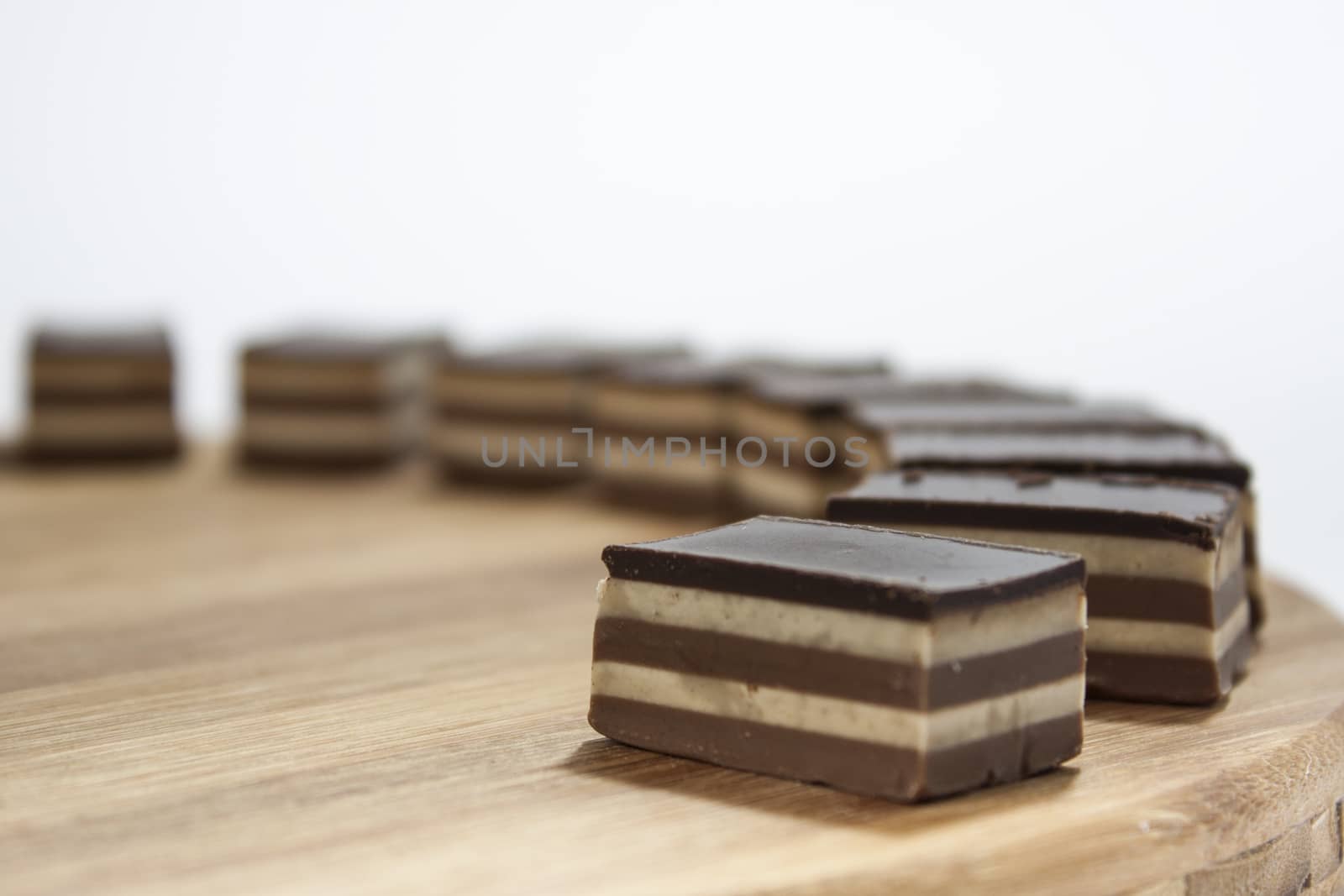 Chocolate cakes lined up on the wooden board.