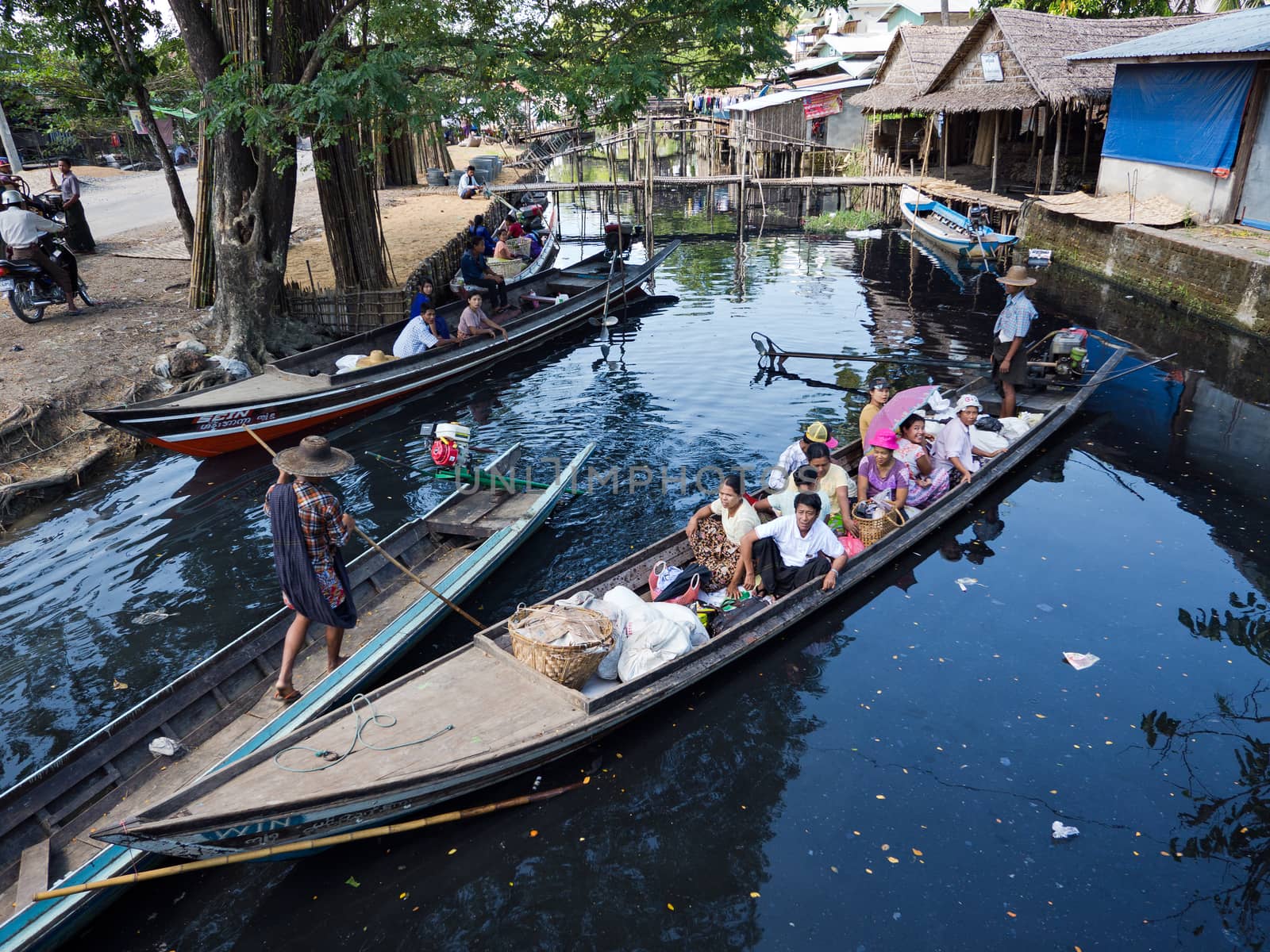 MAUBIN, MYANMAR - NOVEMBER 12, 2014: Passengers on a canal ferry ready to leave Maubin, Ayeyarwady Division in Southwest Myanmar. Many homes in the area lack road connection and can only be reached by boat.