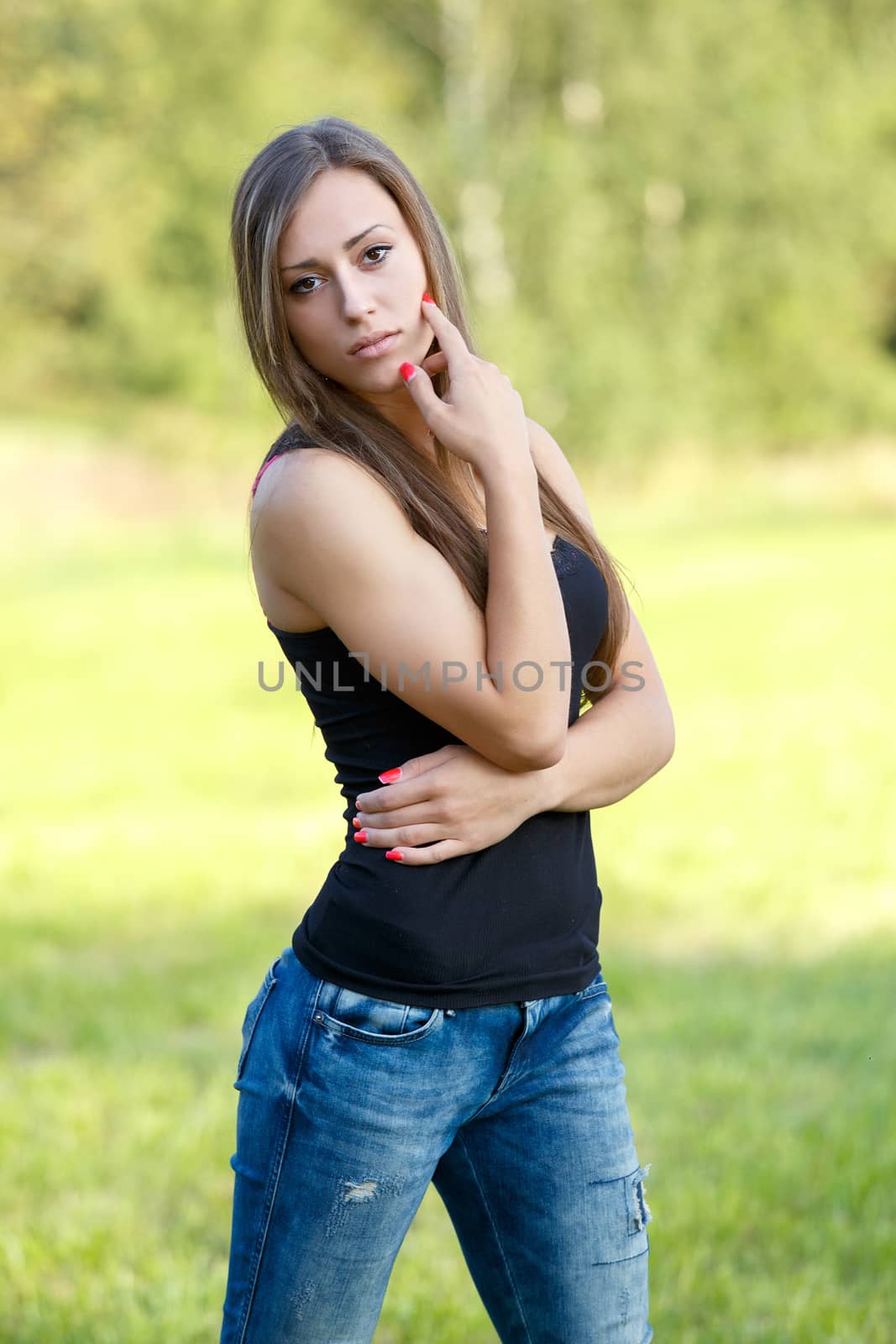 Portrait of smiling and charming lady woman girl outdoor with forrest in background 