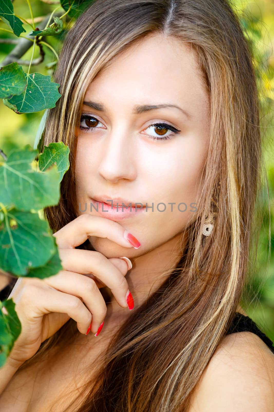 Portrait of smiling and charming lady woman girl outdoor with forrest in background 