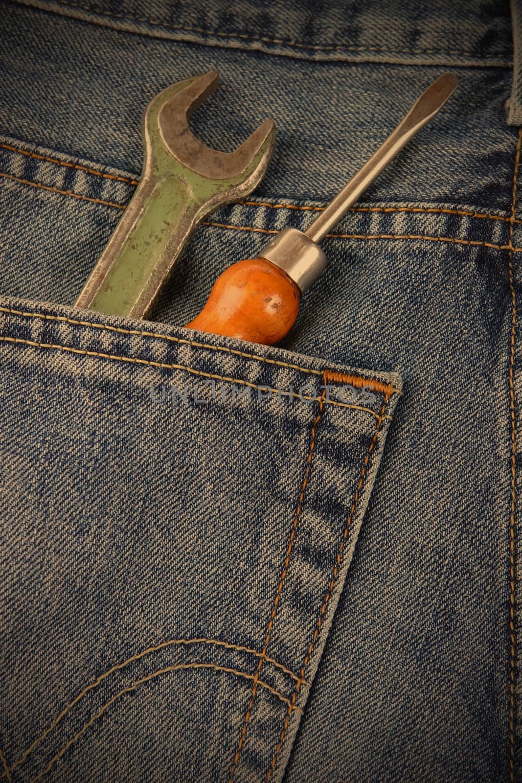wrench and a screwdriver in his pocket jeans workers by Astroid