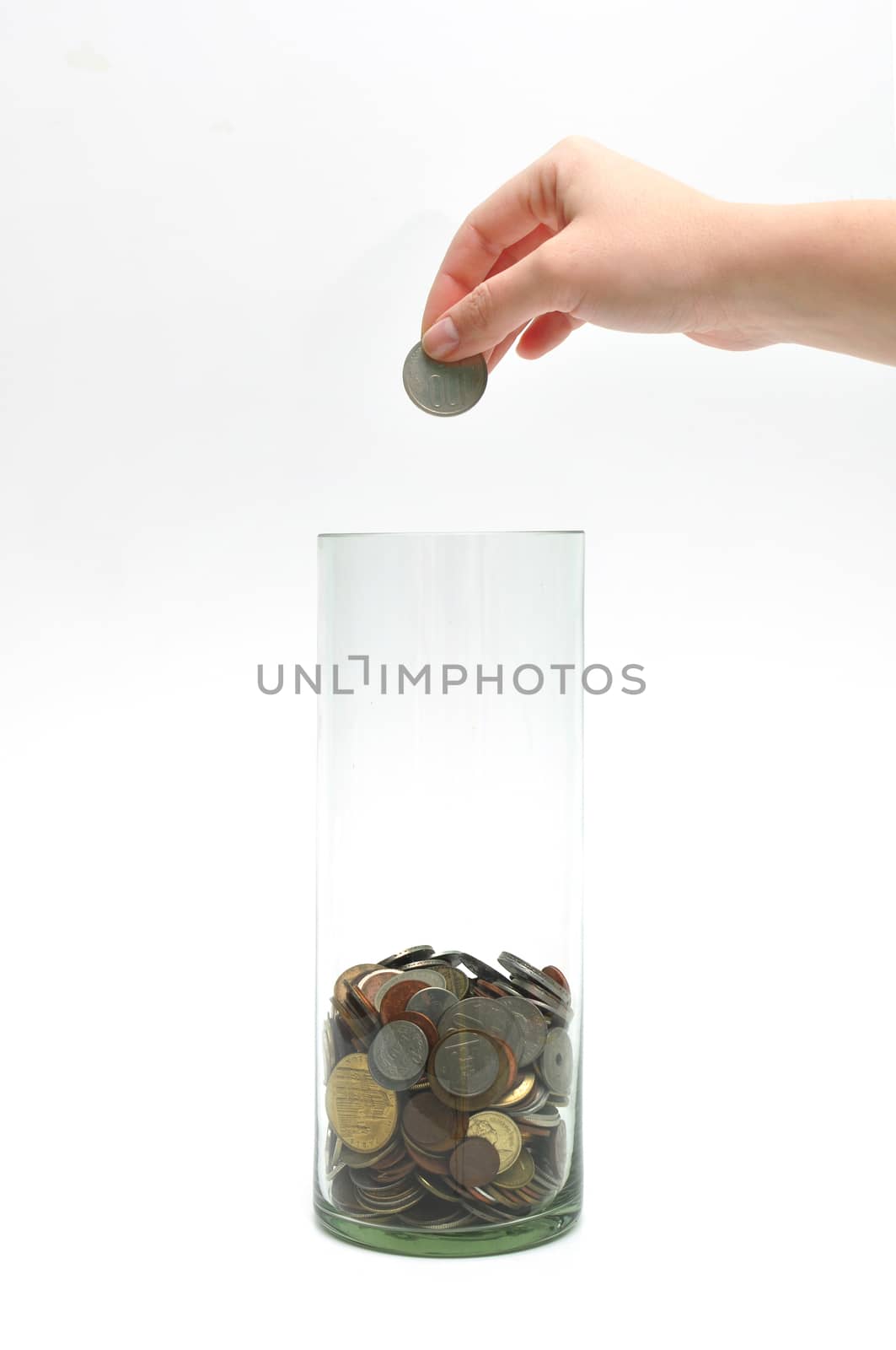 dropping coin into glass jar by tony4urban