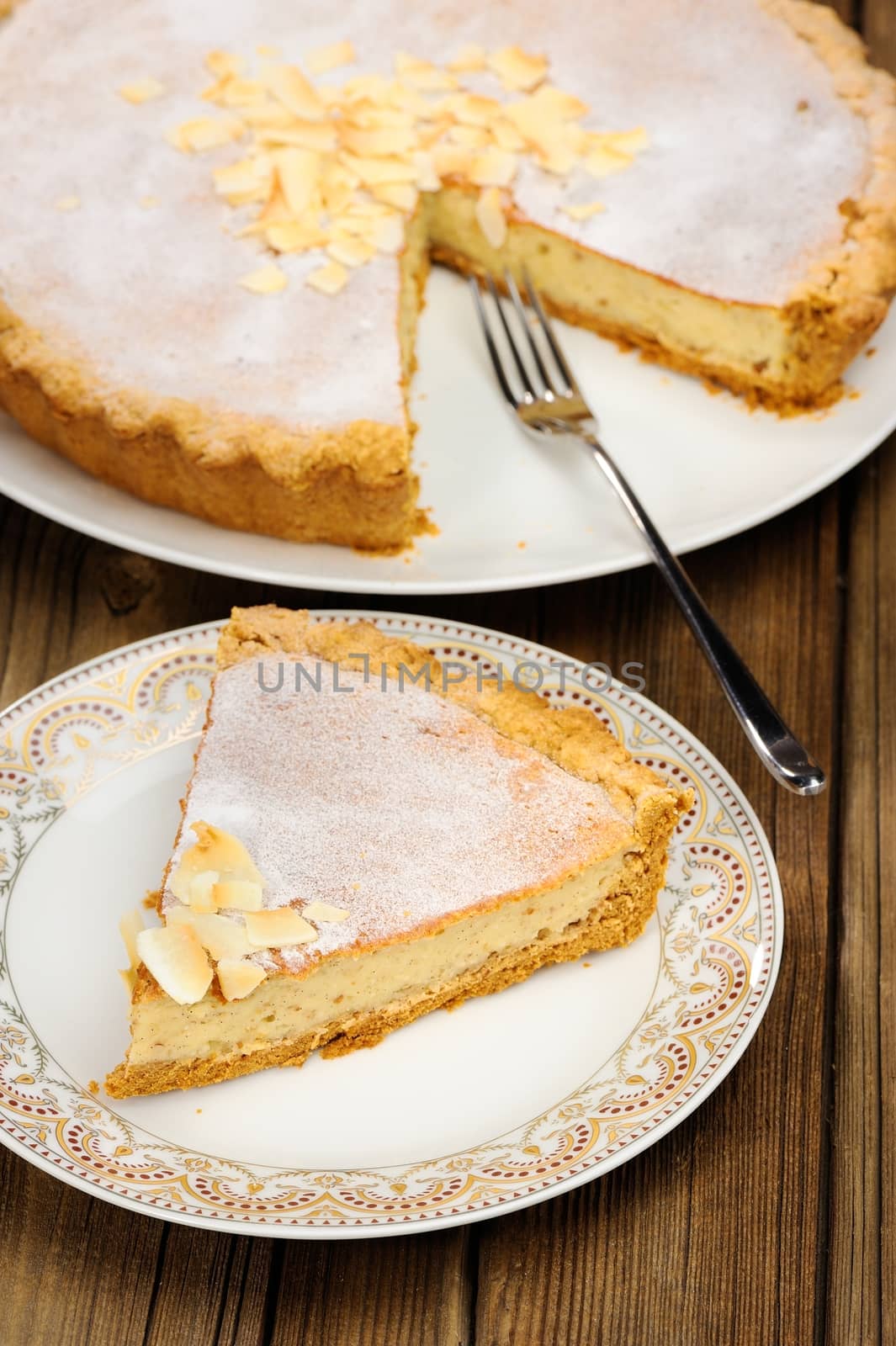 Banana tart piece on wooden background vertical