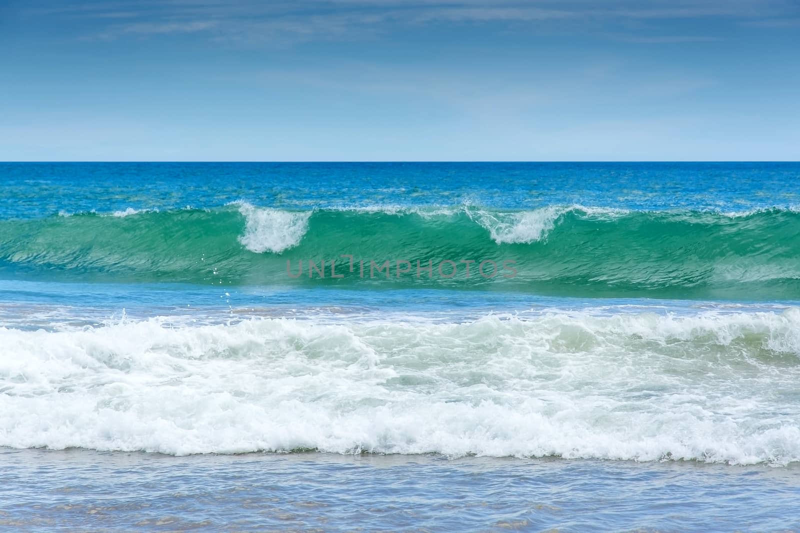 Green wave on sandy beach near Tangalle, Southern Province, Sri Lanka, Asia.