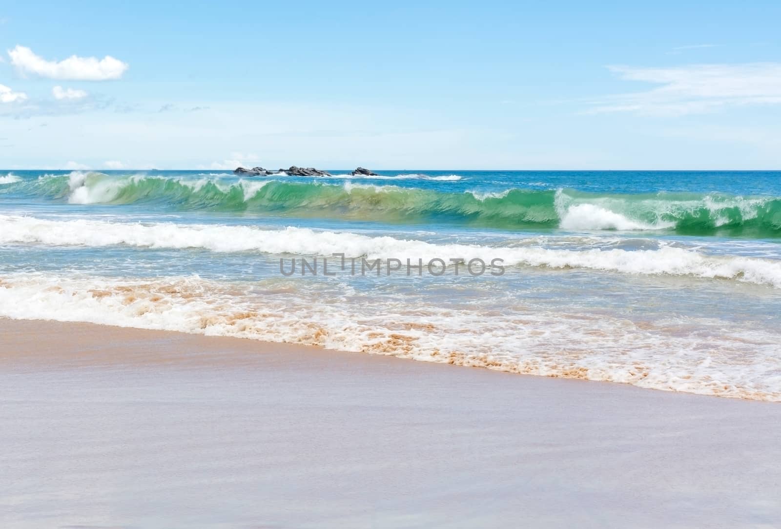 Green wave on sandy beach near Tangalle, Southern Province, Sri Lanka, Asia.