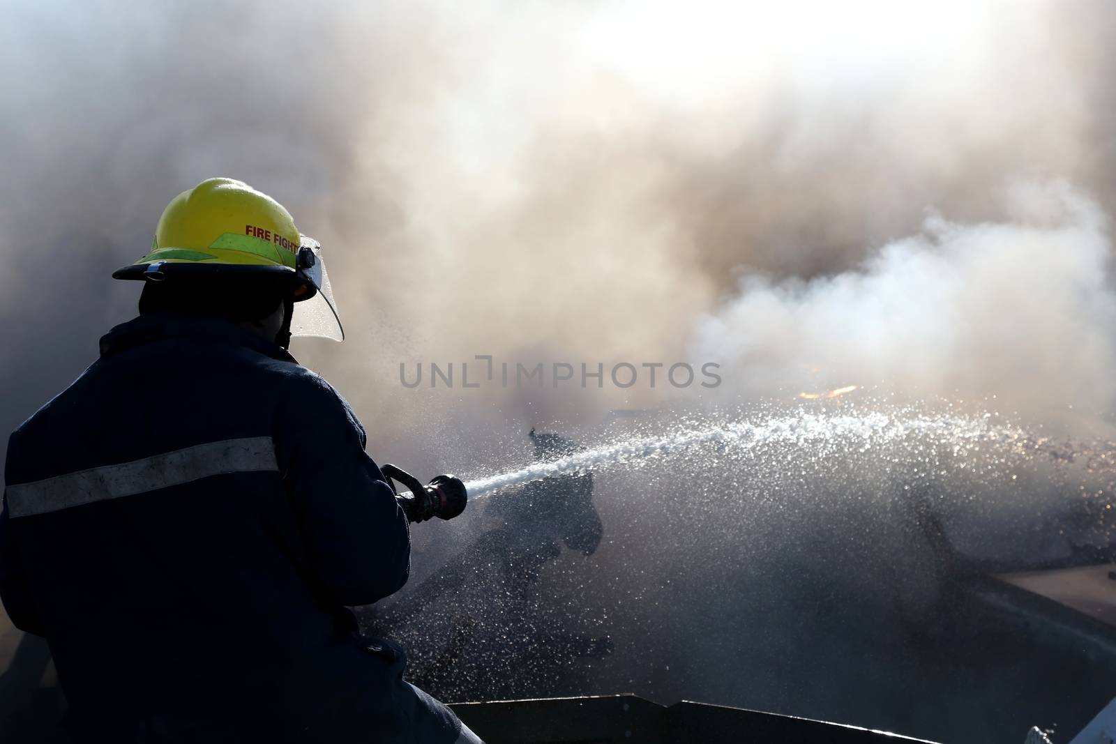 Fireman Putting Out Fire by fouroaks