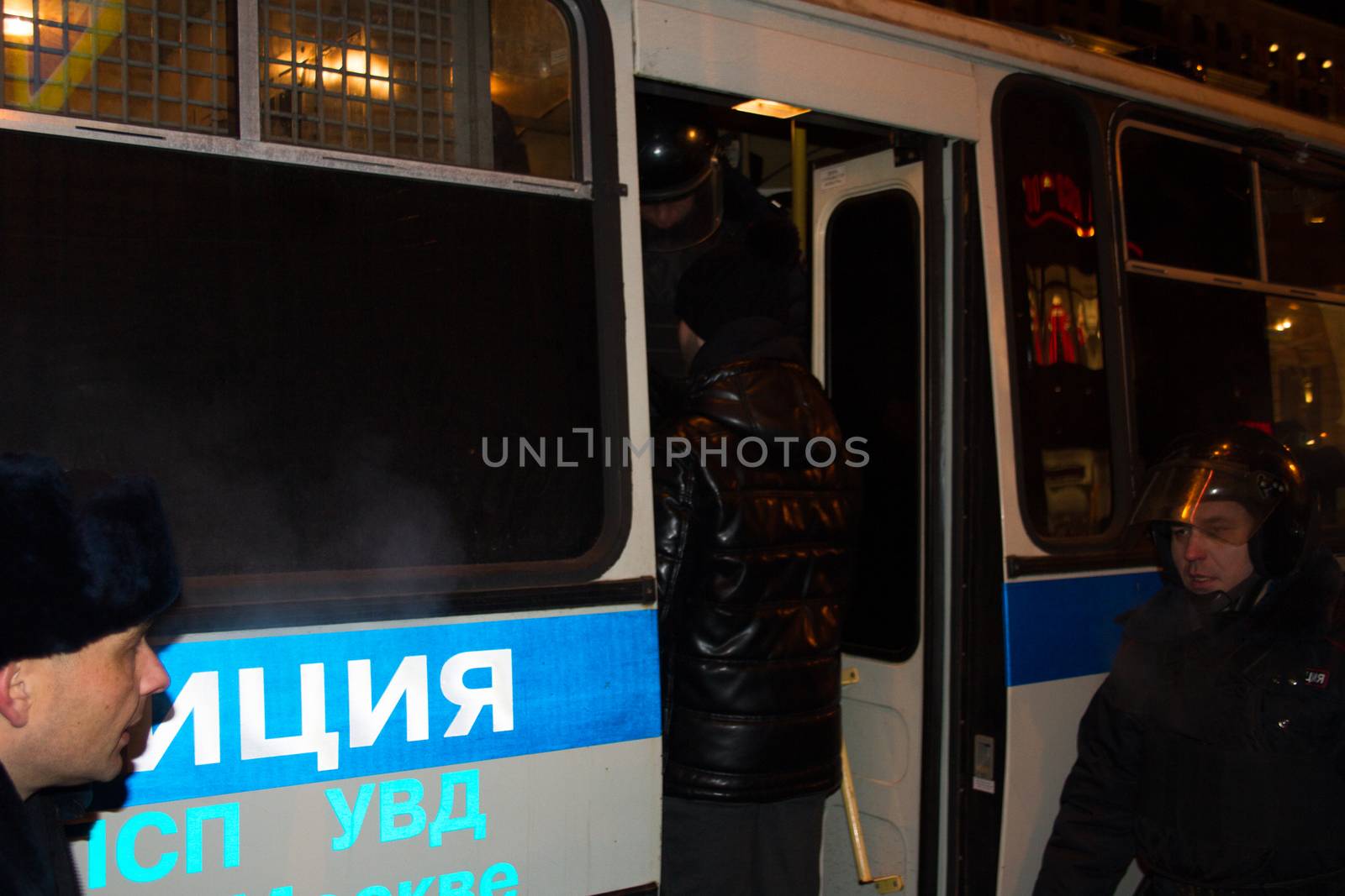 Moscow, Russia - December 30, 2014. In day of a sentence to the oppositional leader Alexei Navalny and his brother Oleg Navalny Muscovites came to a protest action to Manezhnaya Square. Police officers detain protesters in Moscow