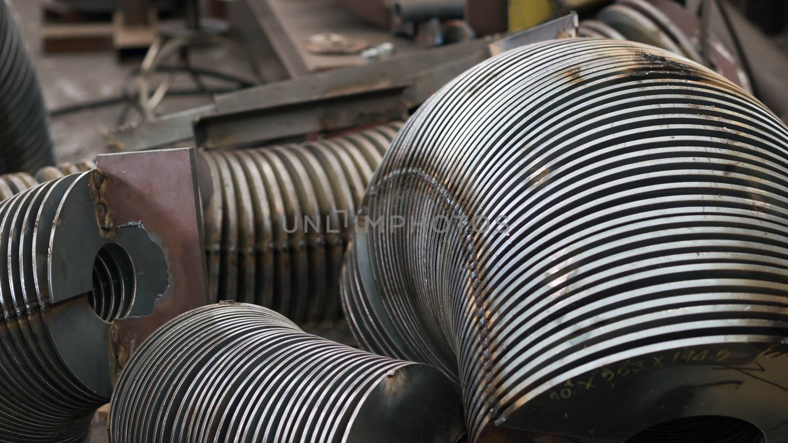 Steel parts for screw conveyors at an early production stage. Shallow depth of field.