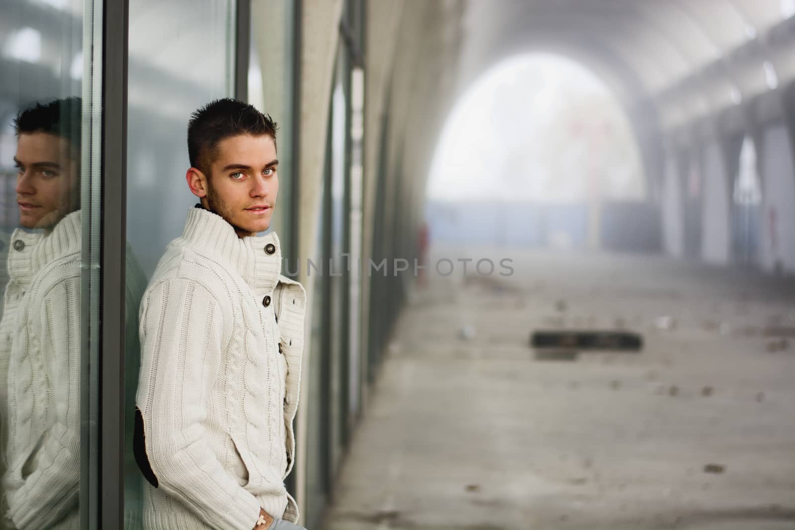 Attractive young man in abandoned empty tunnel by artofphoto