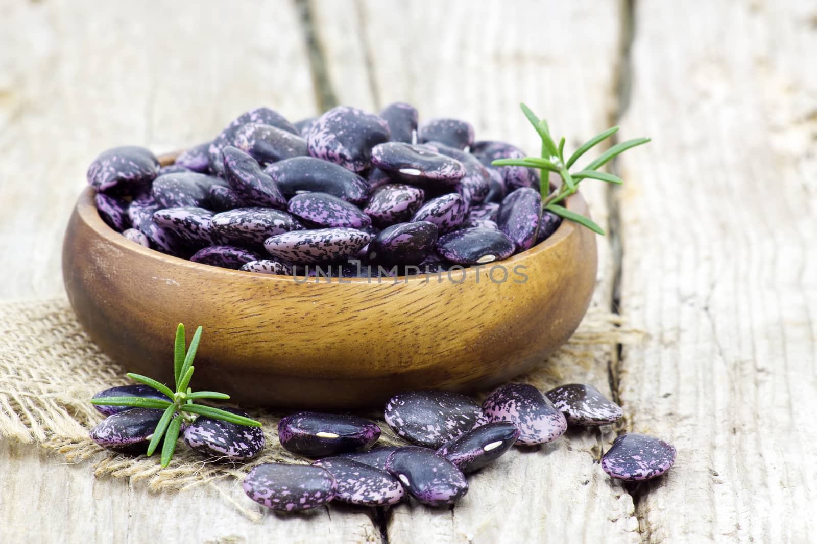 Beans in bowl on wooden background by miradrozdowski