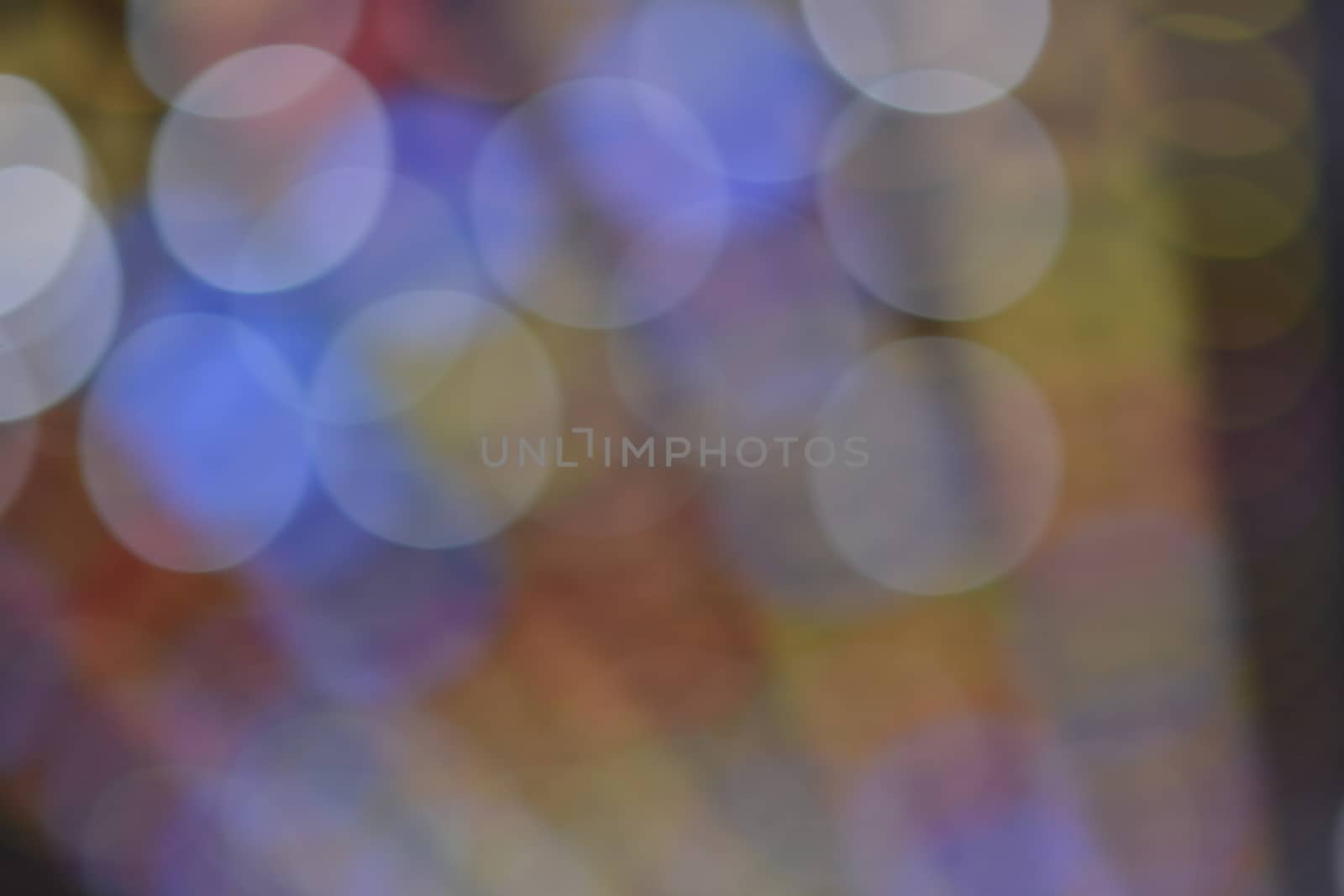 Abstract background made out of de-focused colored lights.