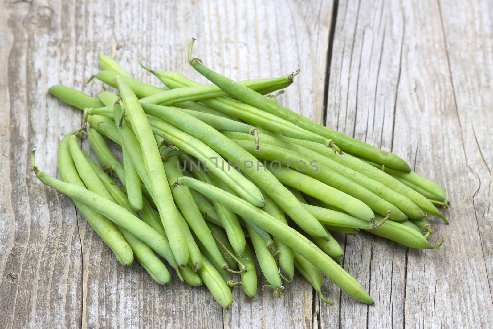 green beans on wooden background