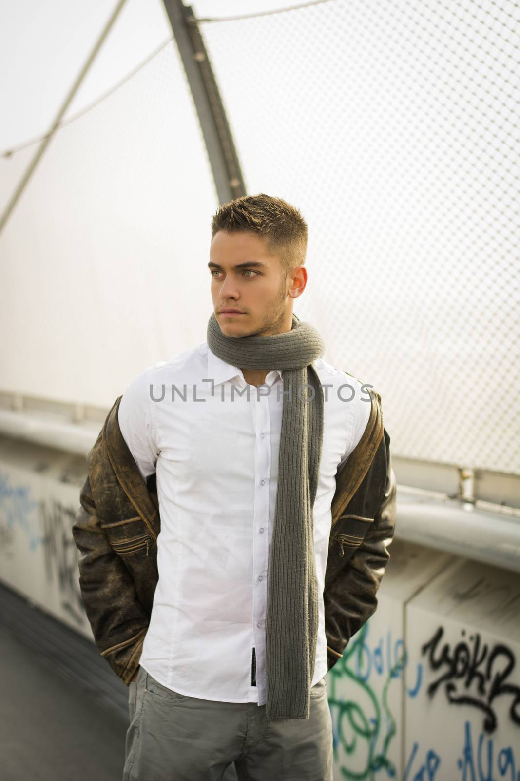 Handsome trendy man standing on a sidewalk by artofphoto