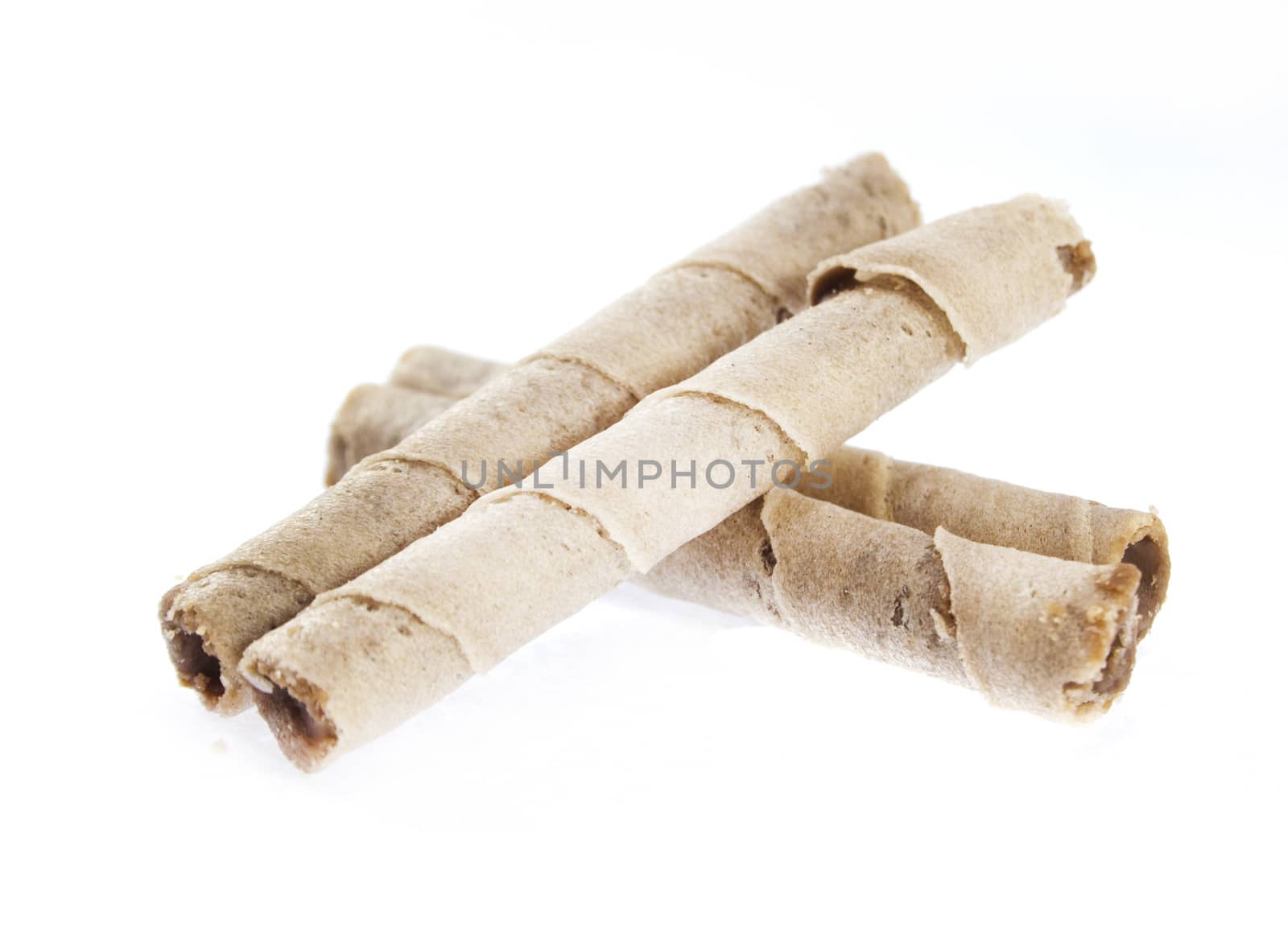 Striped wafer rolls filled with chocolate isolated on white