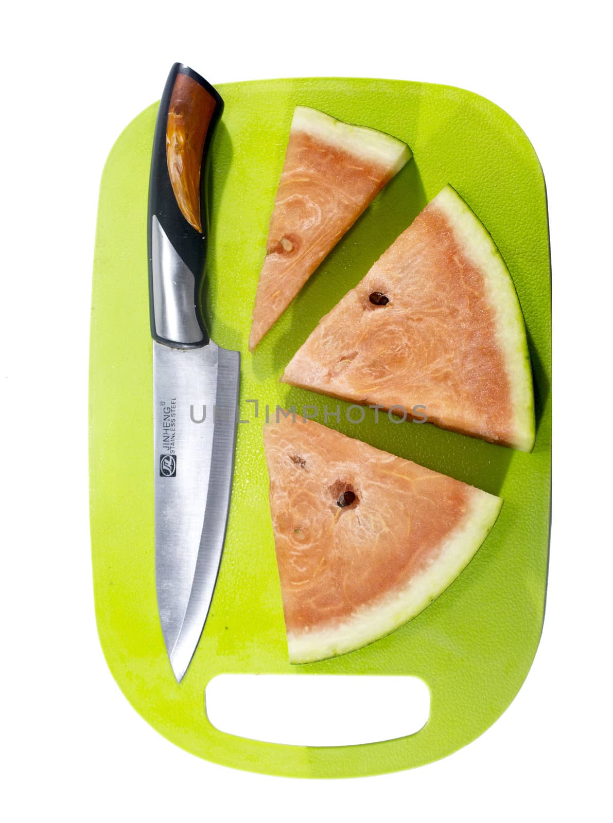 Slices of watermelon on green plastic board with knife.