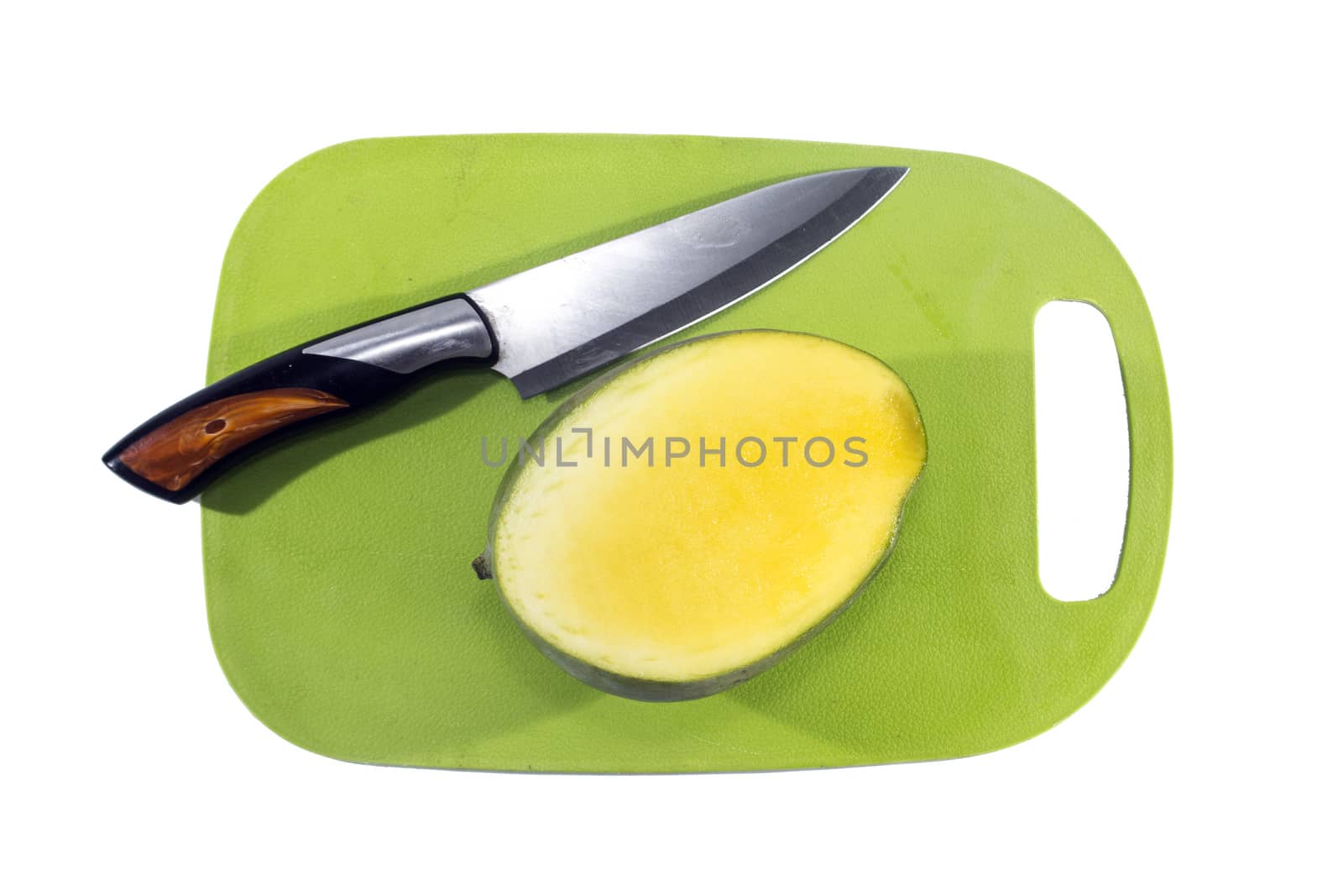 Mango fruit on green plastic board with knife isolated on white background.