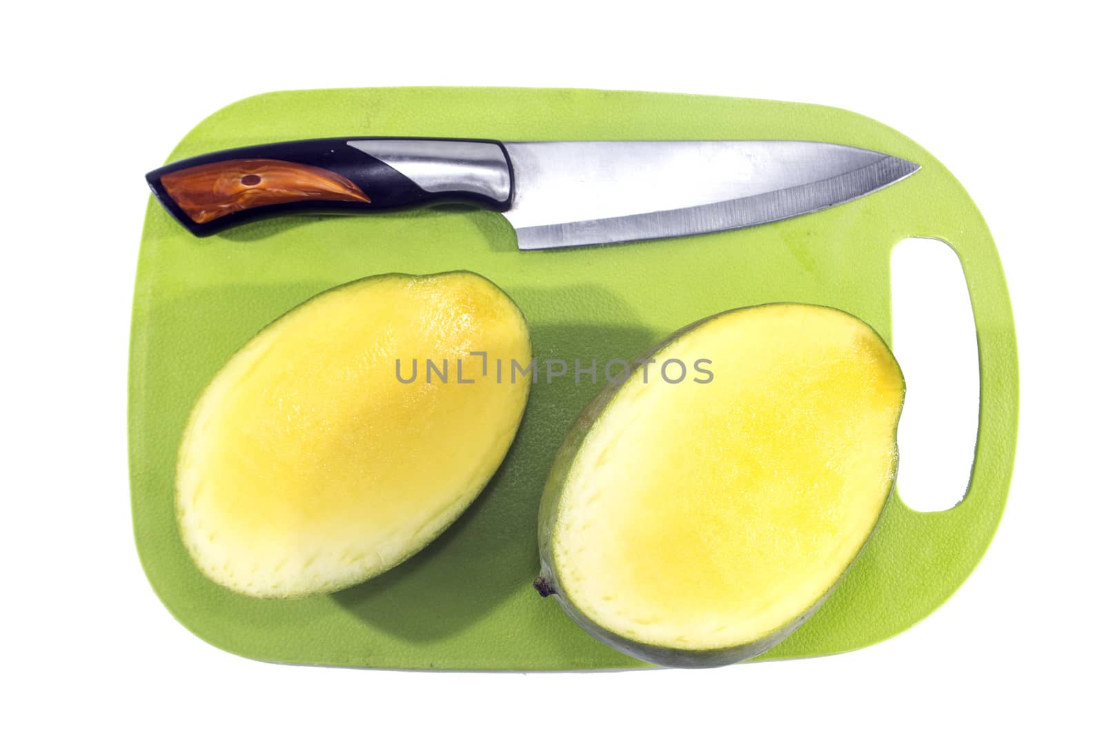 Mango fruit on green plastic board with knife isolated on white background.