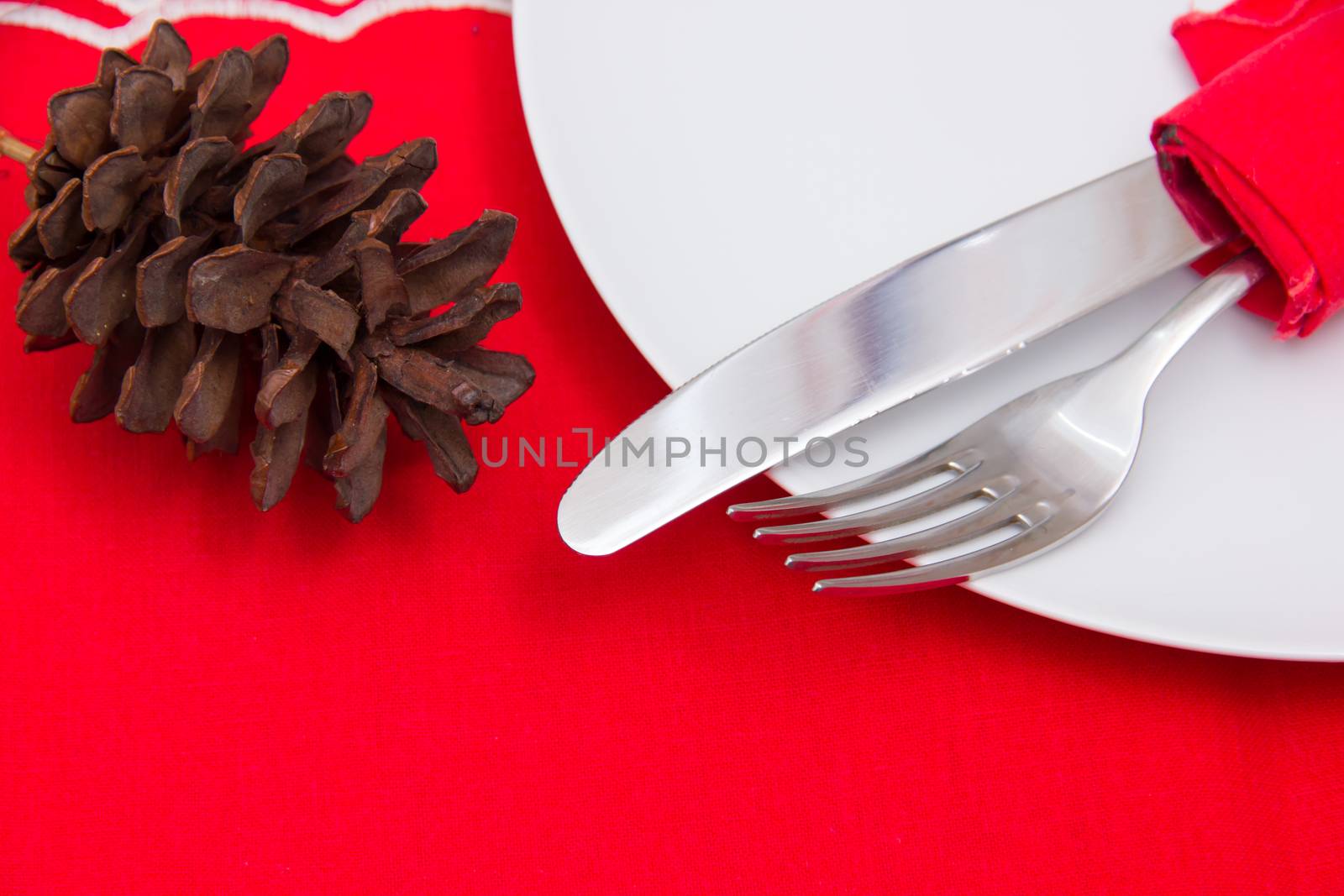 Cutlery on plate with Christmas decorations seen up close