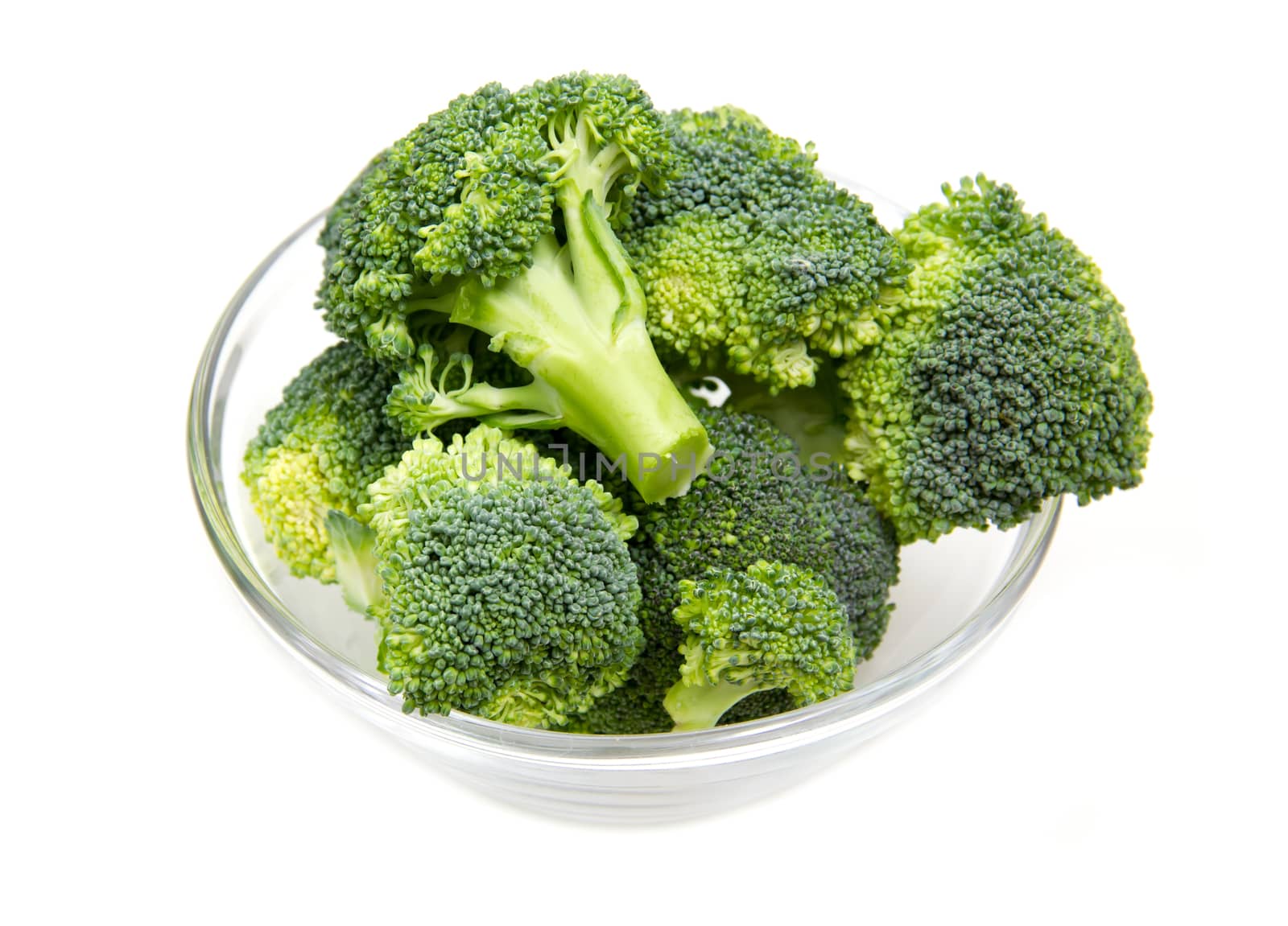 Broccoli in glass bowl on white background