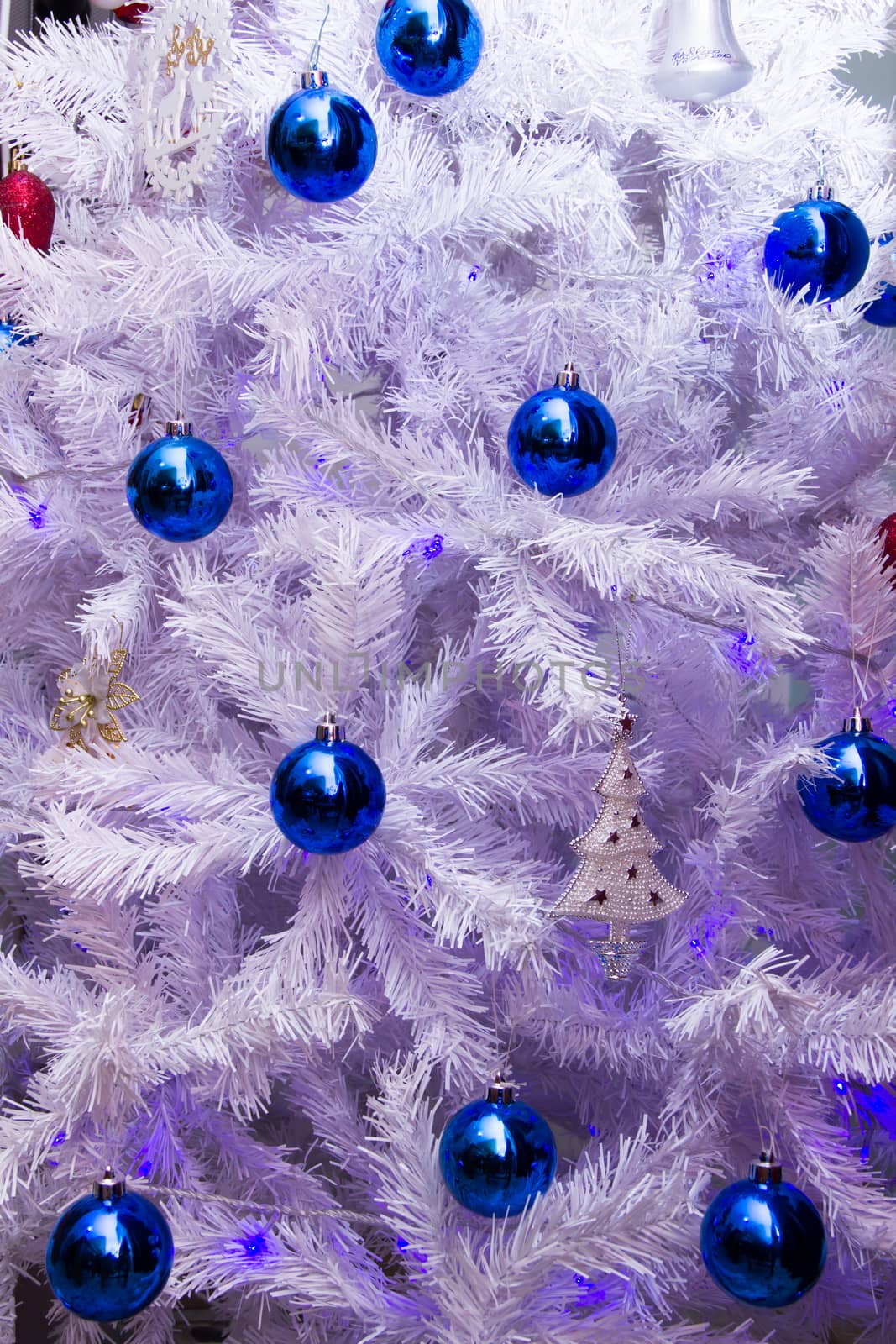 Christmas tree decorations blue on white seen from the front