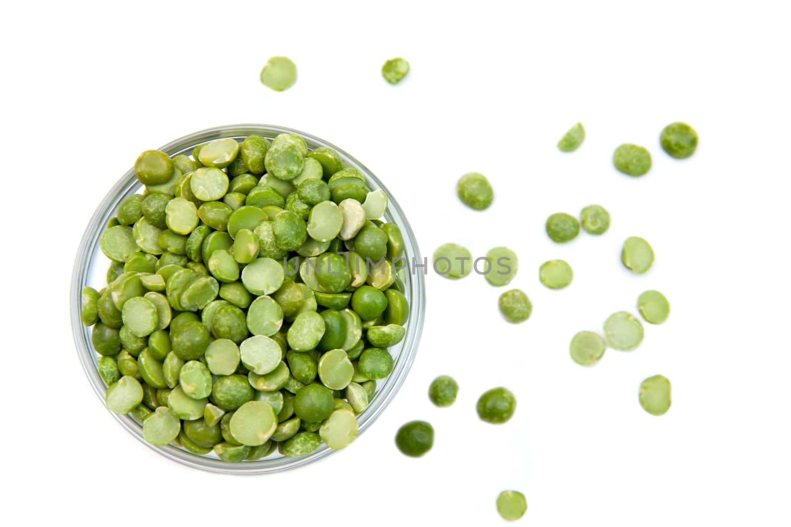 Dried peas in bowl on white background seen from above
