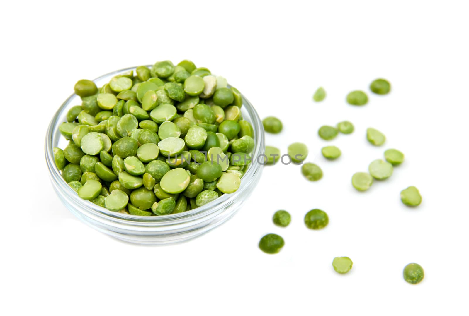 Dried peas in bowl on white background