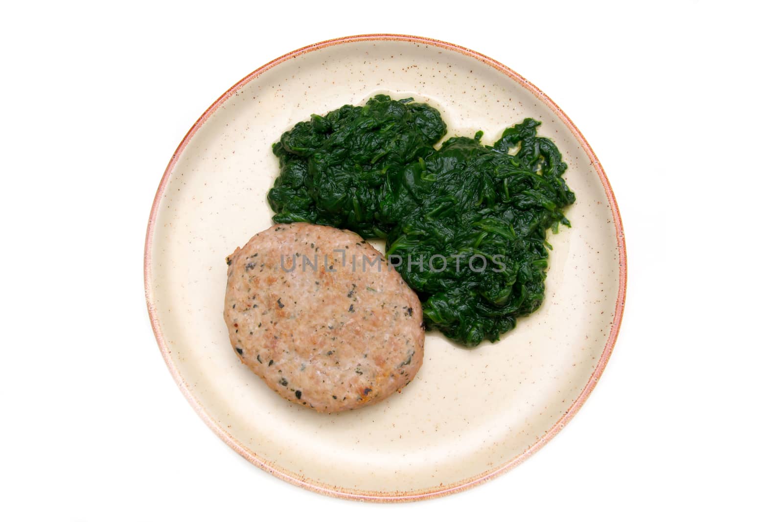 Hamburger meat with spinach on white background seen from above