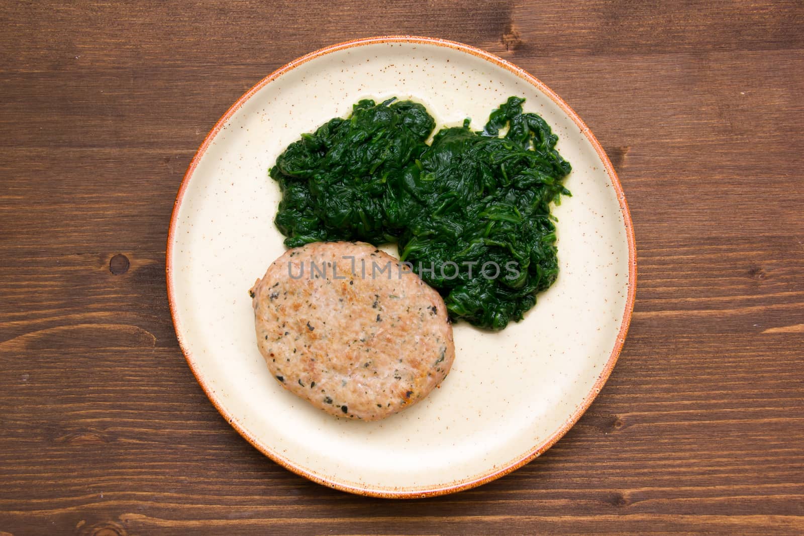 Hamburger meat with spinach on wood from above by spafra