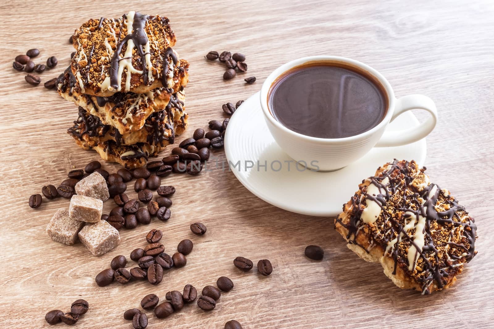 Black coffee in white cup and cookies with frosting