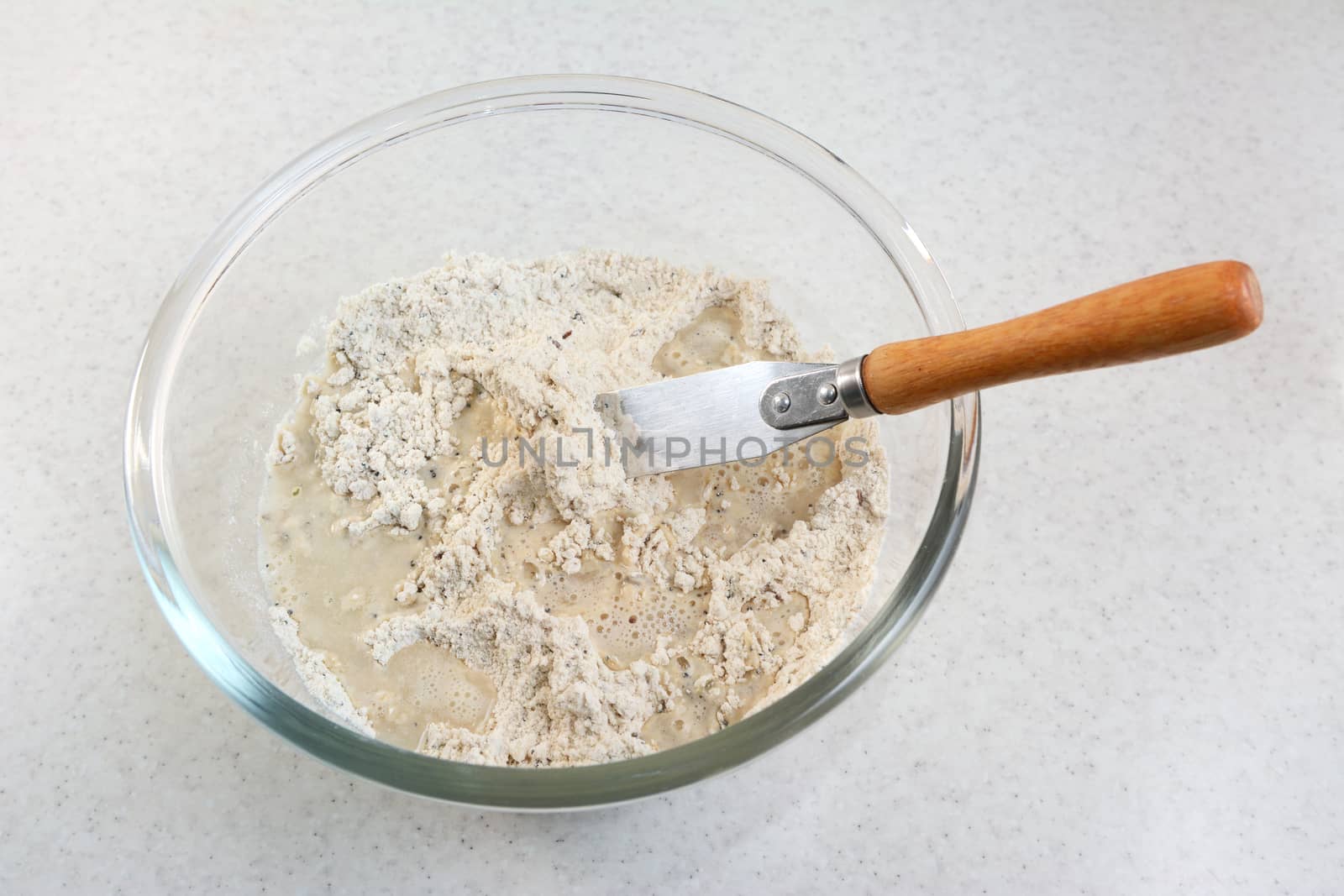 Combining water and bread flour mix with a flat-bladed palette knife