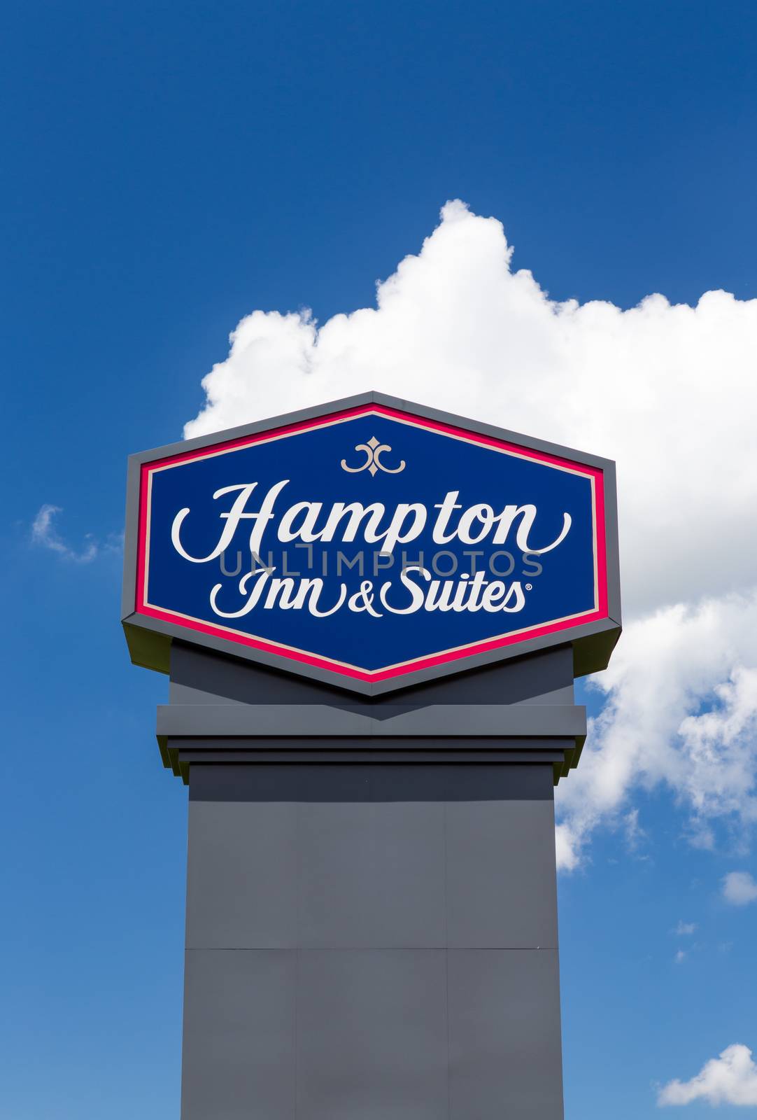 BLOOMINGTON, MN/USA - JUNE 24, 2014: Hampton Inn and Suites sign. Hampton Inn and Suites is a brand of independently owned hotels trademarked by Hilton Worldwide.