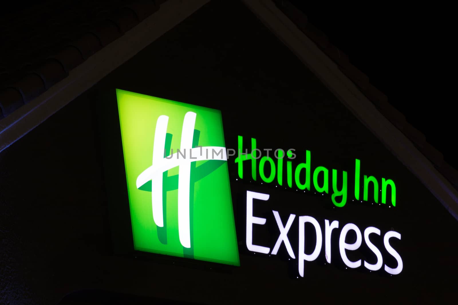 LANCASTER, CA/USA - APRIL 19, 2014: Holiday Inn Express Sign at night. Holiday Inn Express is a mid-priced hotel chain branded by InterContinental Hotels Group.