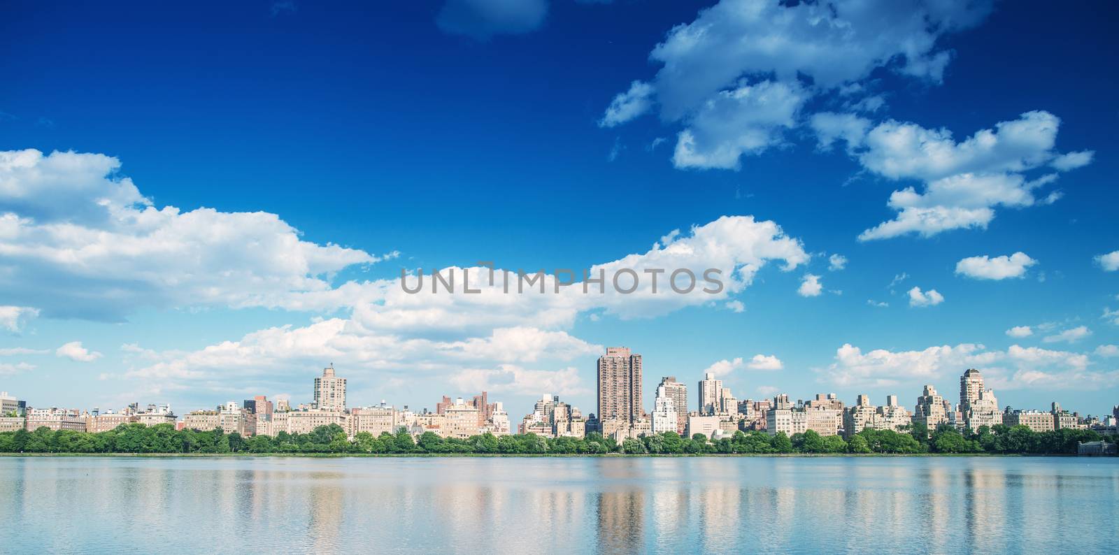 Manhattan buildings over Central Park Lake, New York City.