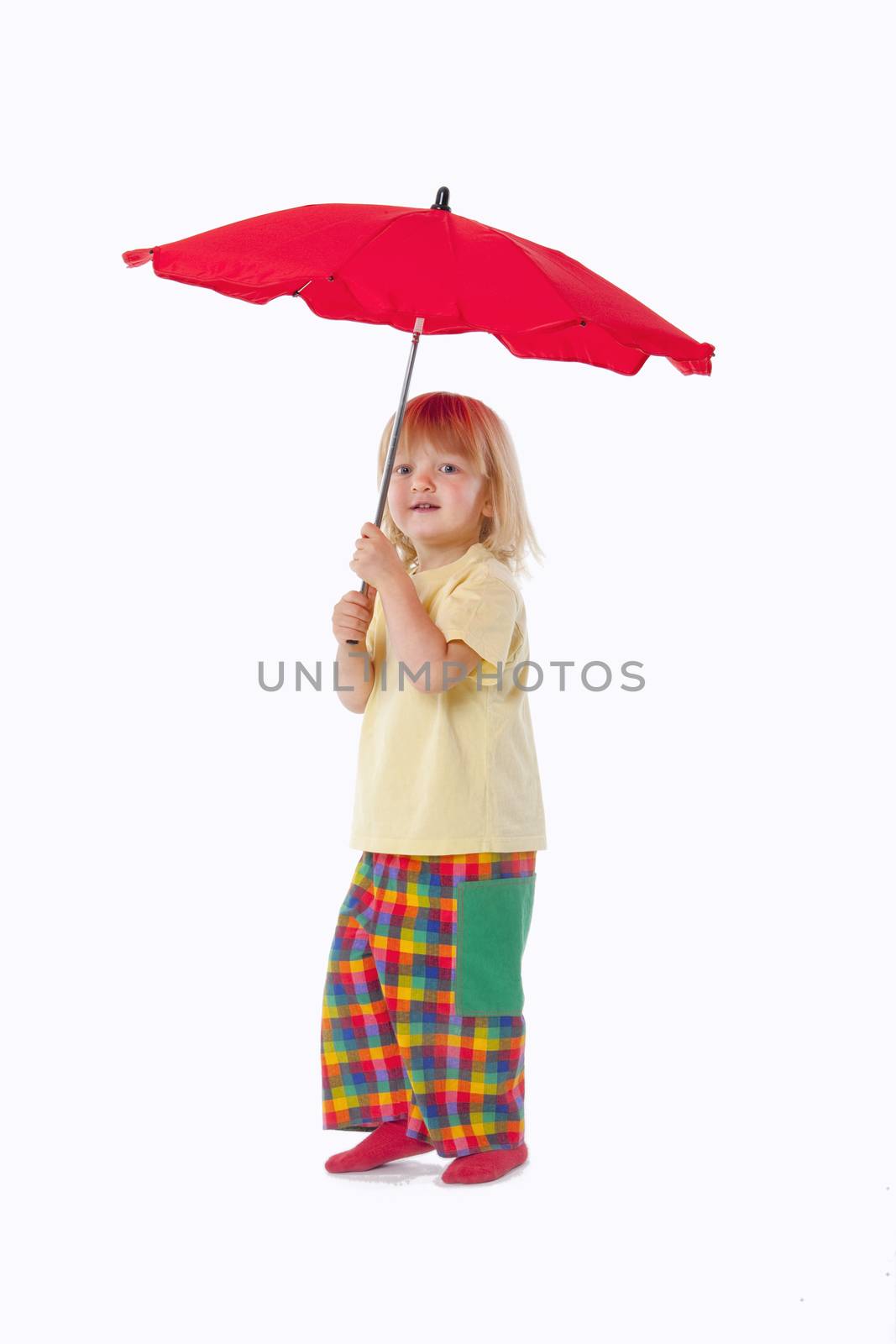 boy with long blond hair playing with a red umbrella