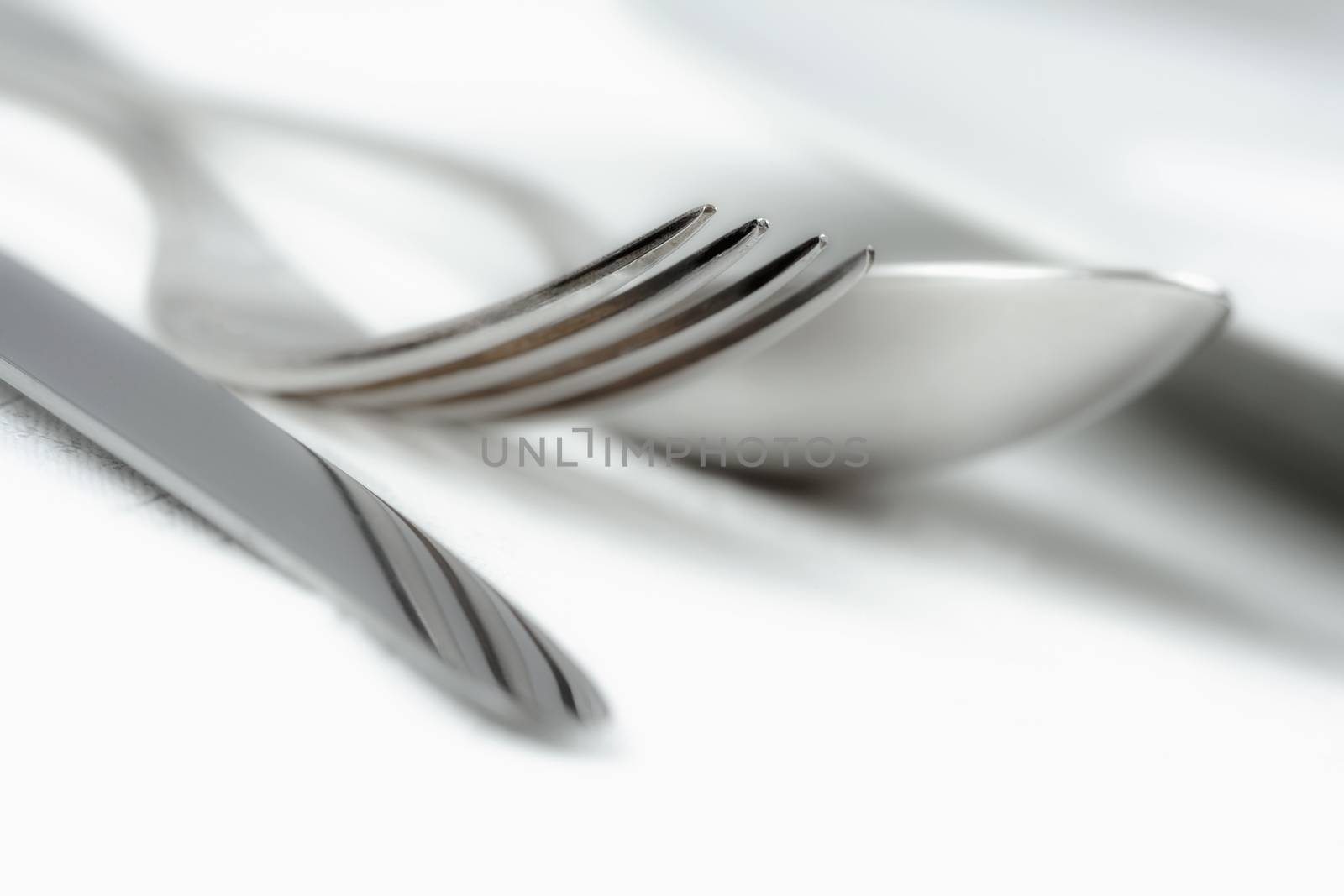elegant table setting with silverware on white cloth