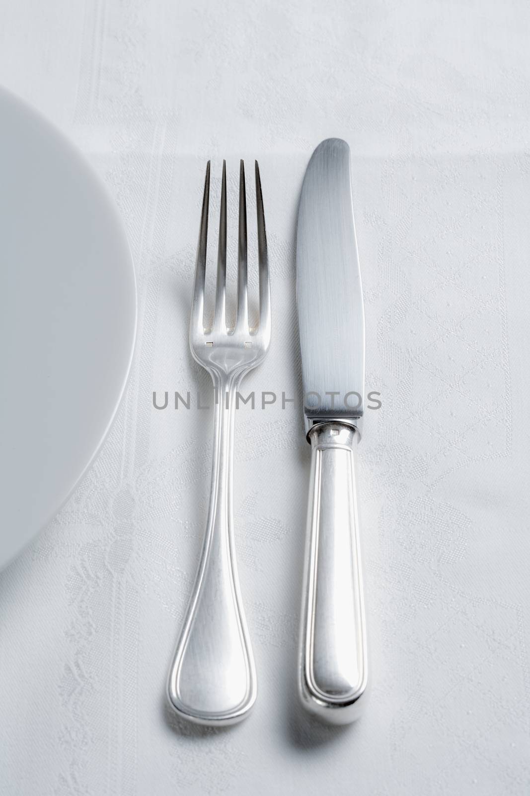 elegant table setting with silverware and white plate