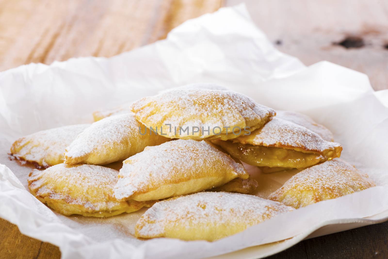 Close up Delicious Cookies with Sugar on Plate with White Paper, Placed on Wooden Table.