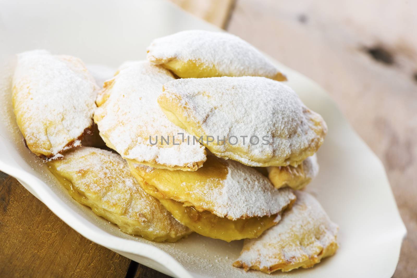 Close up Delicious Cookies with Sugar on Plate with White Paper, Placed on Wooden Table.