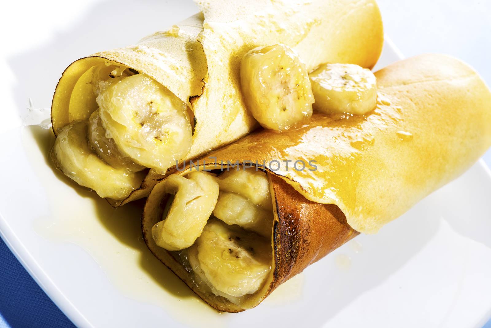 Delicious freshly baked pancakes or crepes filled with banana a gourmet dessert