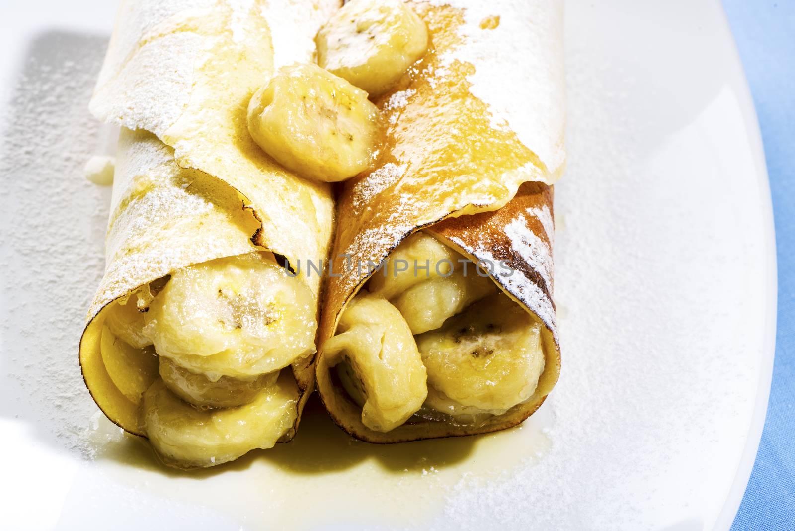 Delicious freshly baked pancakes or crepes filled with banana a gourmet dessert