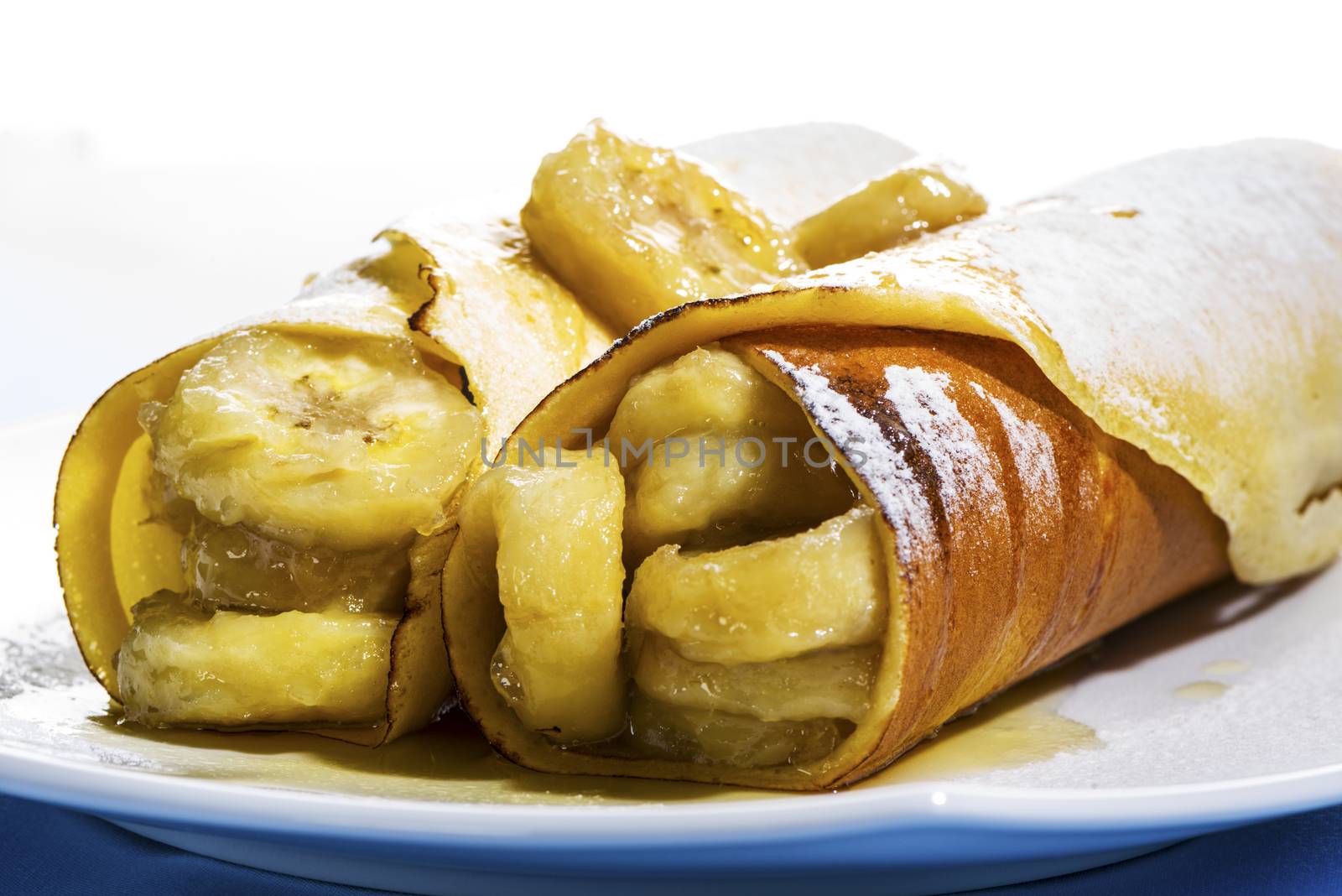 Delicious freshly baked pancakes or crepes filled with banana a gourmet dessert