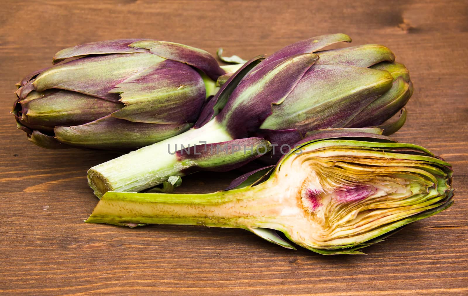 Artichoke cut in half on wood by spafra