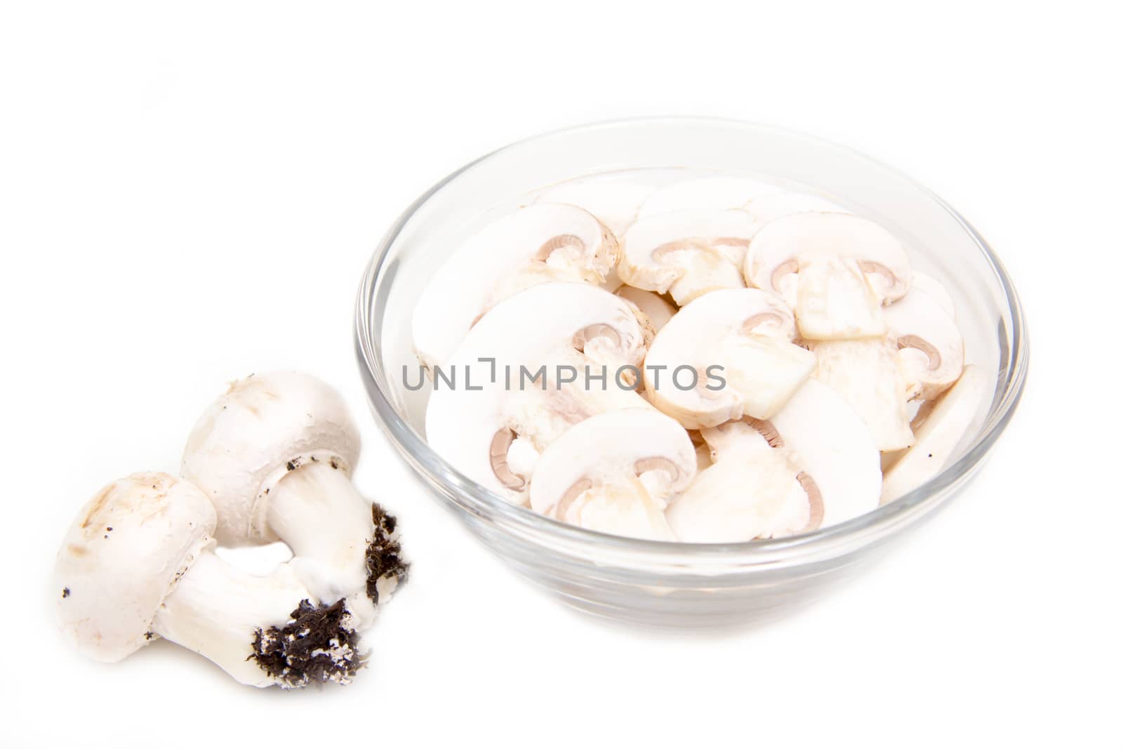 Sliced mushrooms in bowl on white background