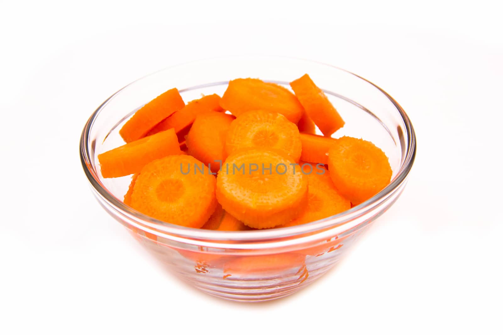 Carrot slices on bowl on white background