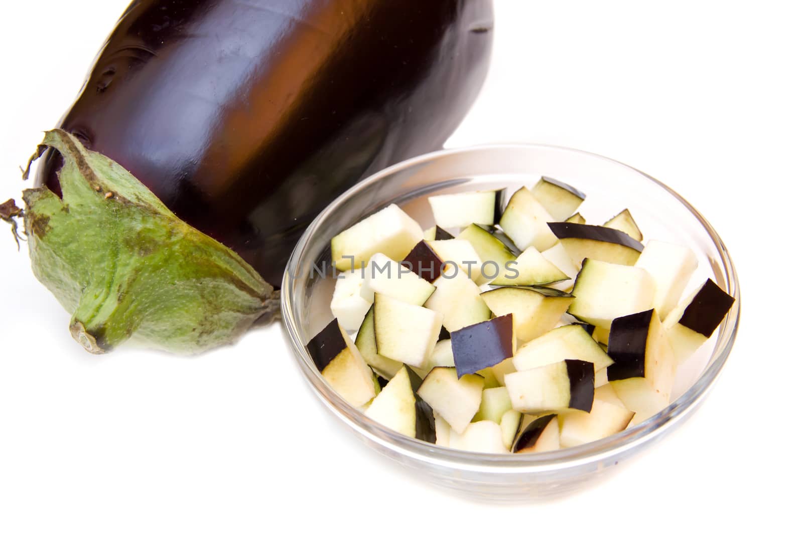 Cubes of eggplant on bowl on white background