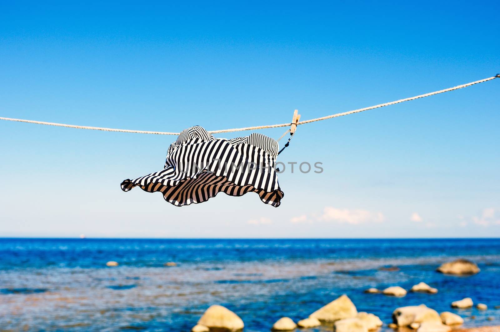 Striped top hanging on a rope on the beach